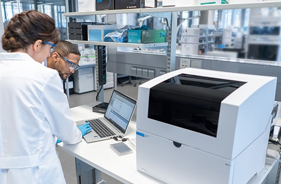 Photo of two scientists looking over a computer