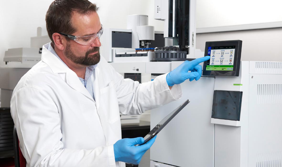 Lab technician working with an Agilent GC system